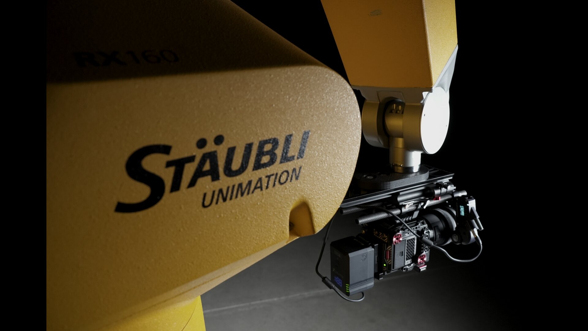 Close-up of the Stäubli RX160 wrist with the RED Komodo camera rig mounted